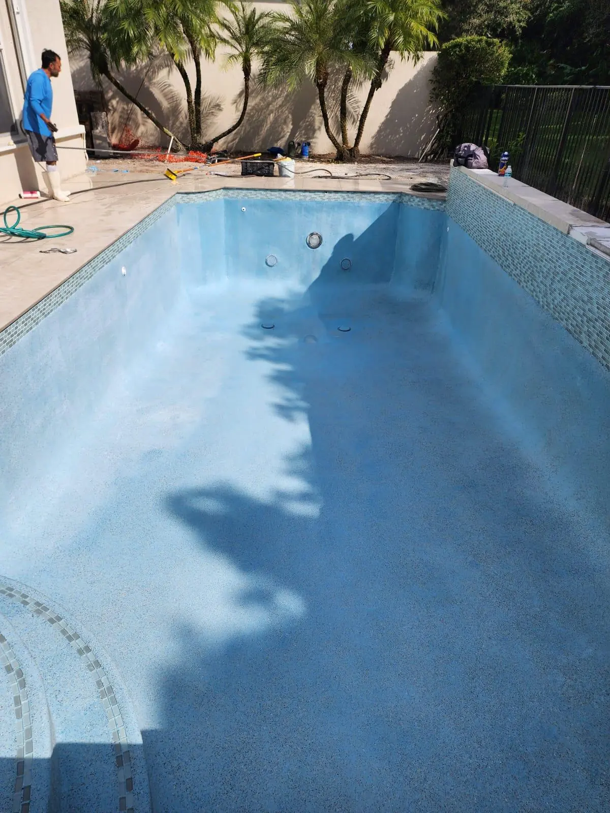 New light blue interior finish in a drained pool, ready to fill
