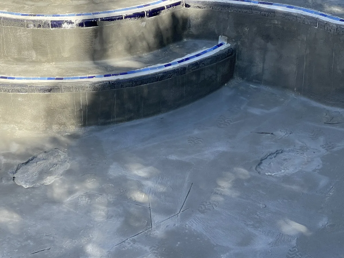 Curved pool bench prepped for finish under a new glass tile waterline
